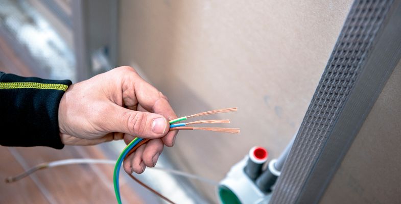 Electrician installing cable