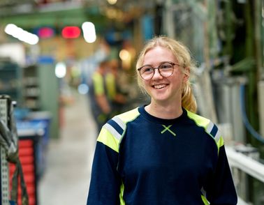 Employee smiling in production hall